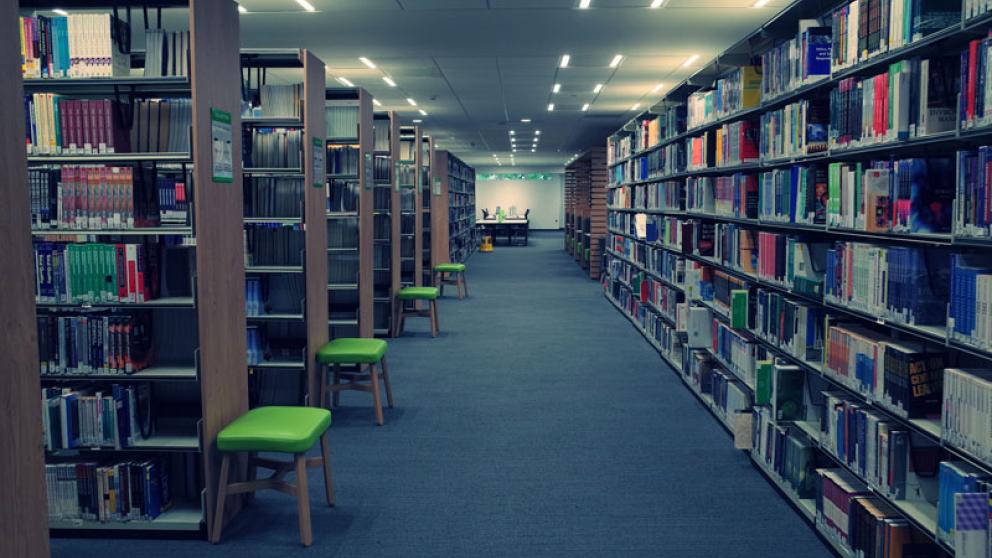 Books and shelving inside the Clifford Whitworth Library, University of Salford
