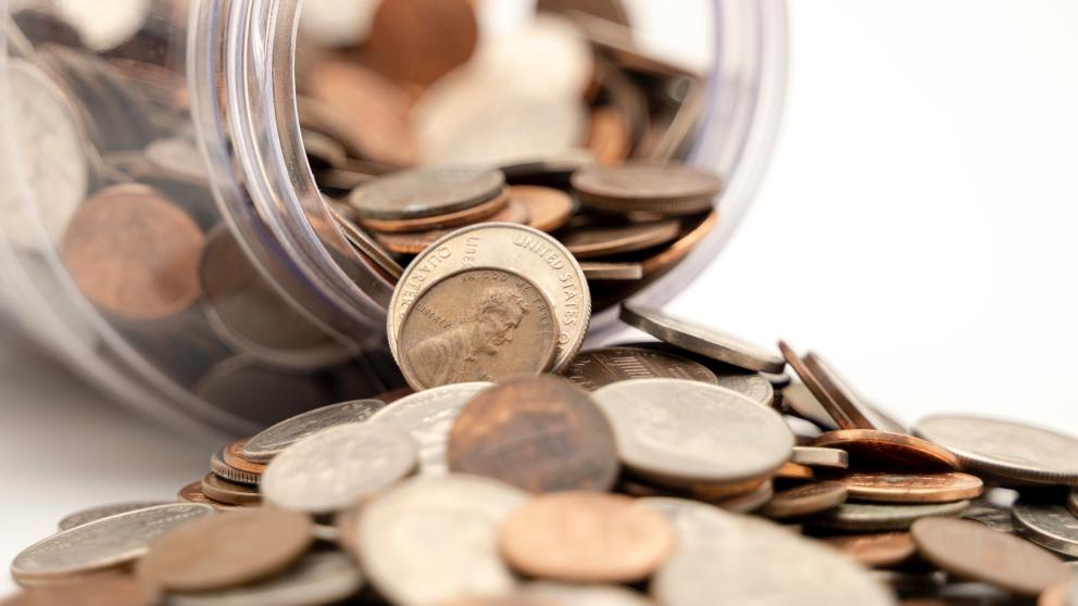 Coins spilling from jar