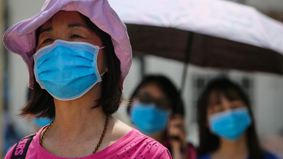 People wearing blue disposable surgical face masks