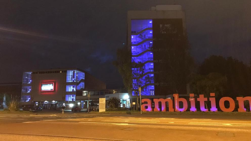 Maxwell Building at night with ambition sign