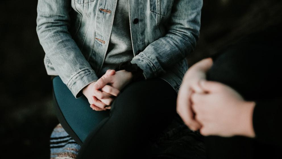 Two people hold a discussion