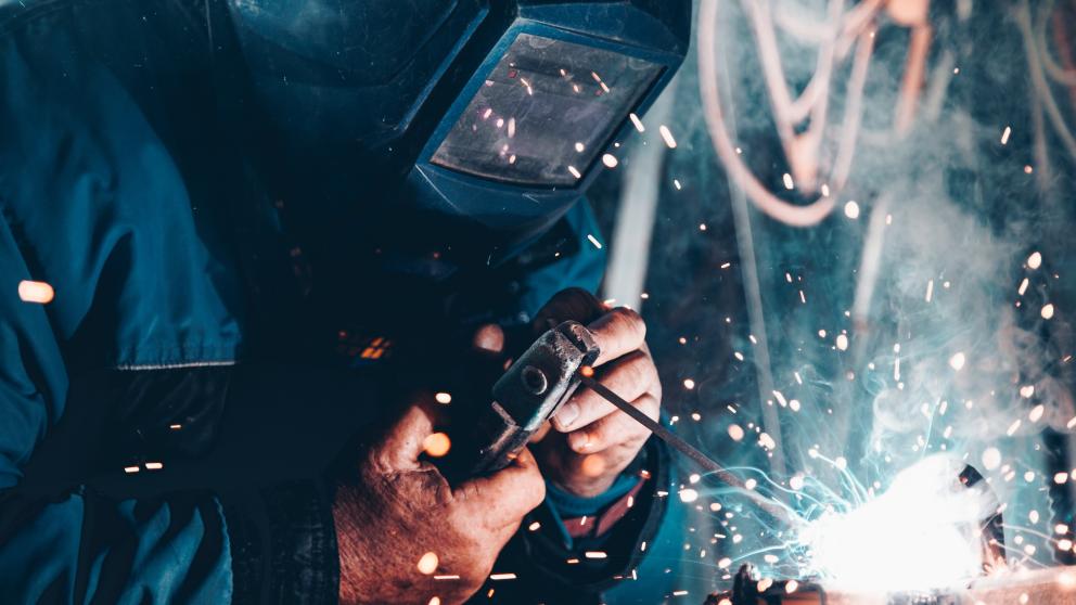 Operator welding a section of piping