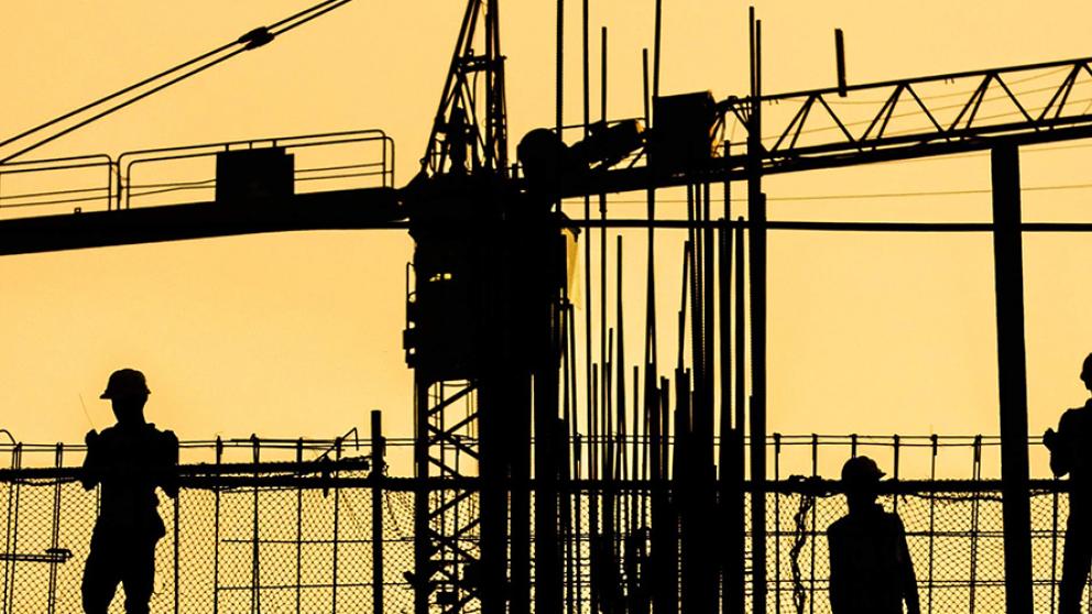 A silhouette of construction workers