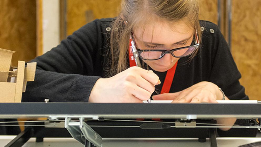 Student using an architects drawing board