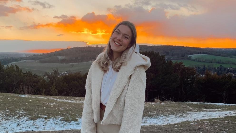 Gemma Gosden stood on hillside with sunset