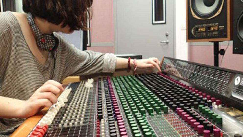 Person sat in a sound mixing studio