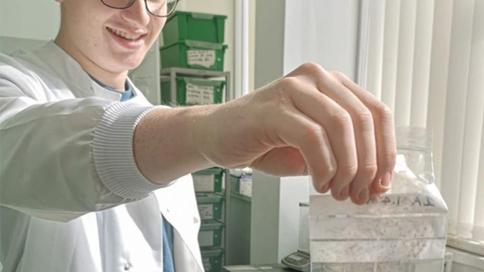 Geography degree student holding a sample
