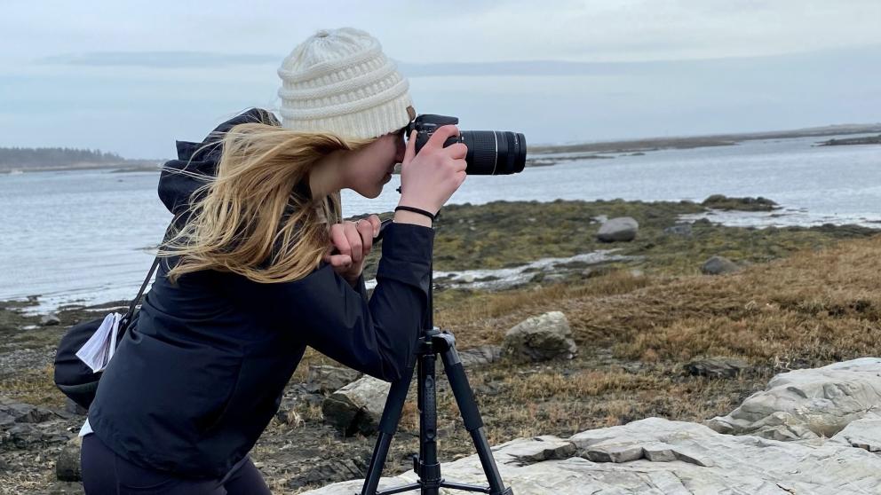 Photographer with camera on a tripod