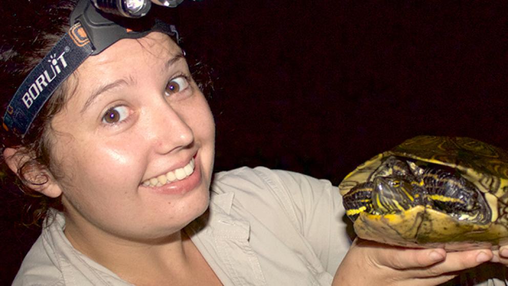 Wildlife student holding a turtle