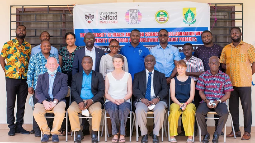 The POCUS team sat in front of a banner 