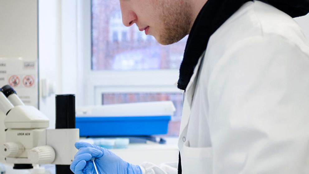 Science student working with laboratory equipment