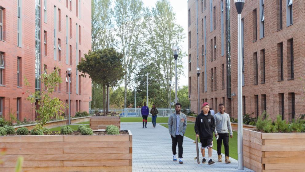 Students outside Peel Park Quarter student accommodation, University of Salford
