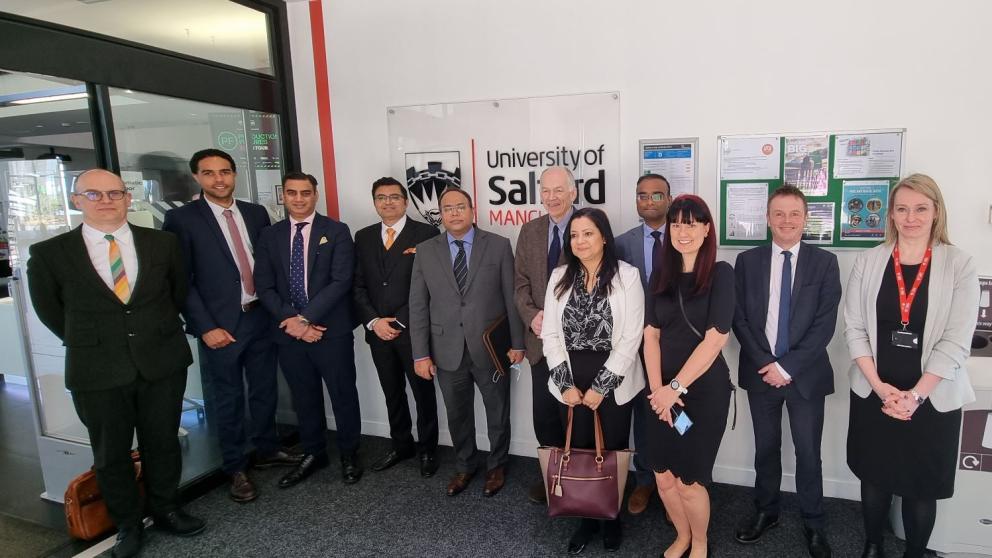 A group photo of India's Deputy High Commissioner and delegation with University of Salford staff.