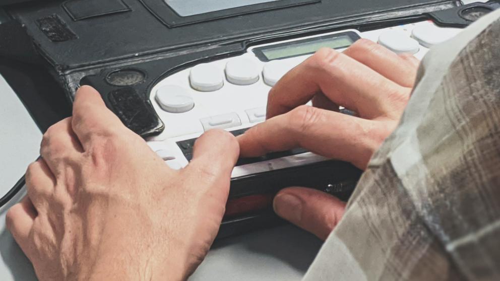 A person using an adapted keyboard