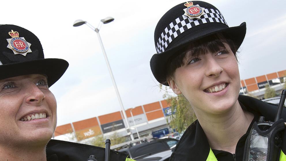 Two police constables in a shopping estate car park