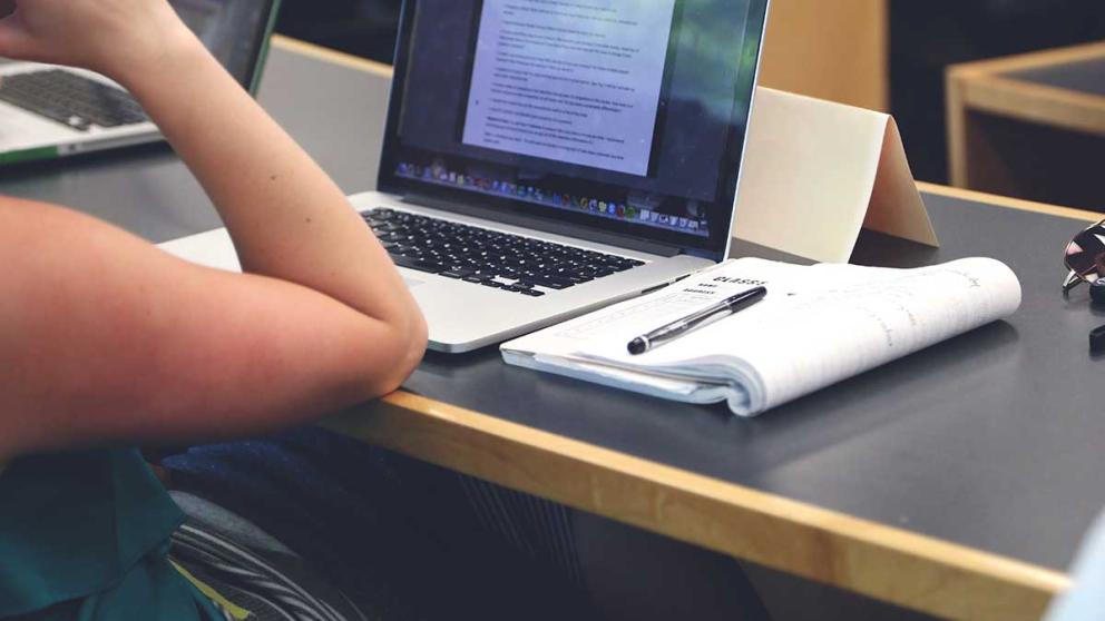 A student works on a laptop 