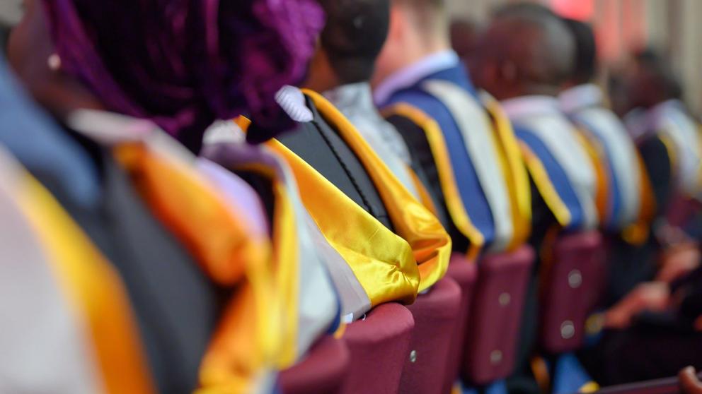 Row of seated graduates at a graduation ceremony