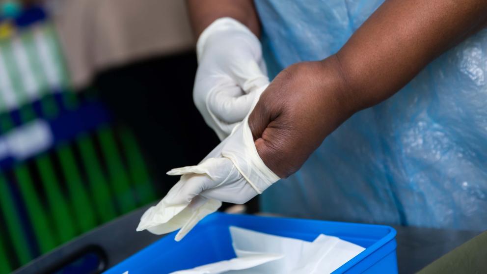 Nurse putting on gloves