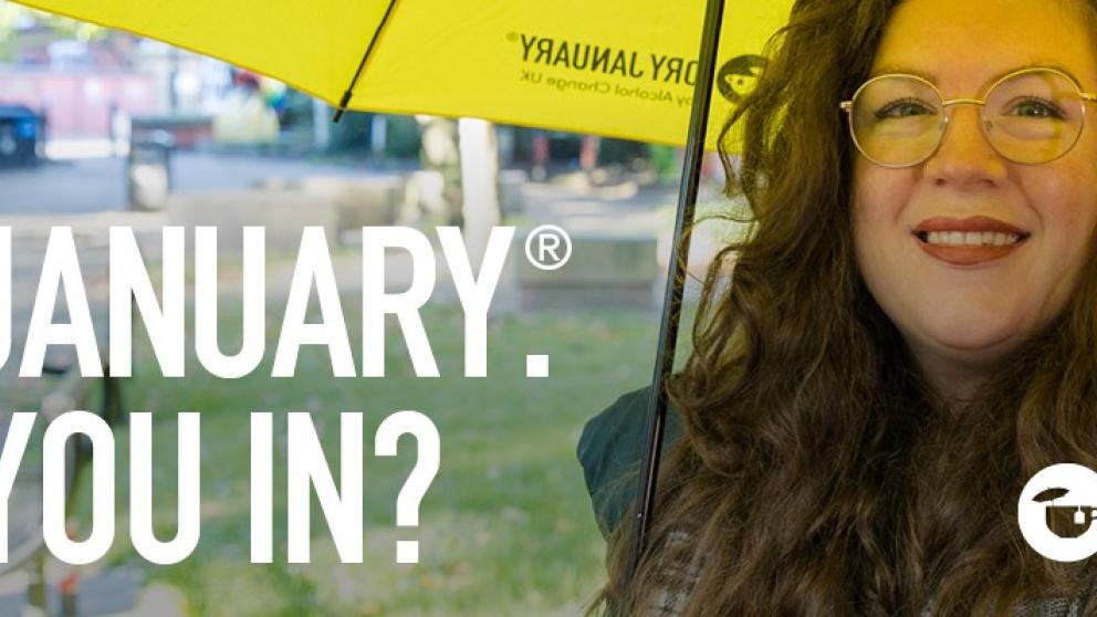 A campaign image for Dry January, showing a smiling woman stood under an umbrella