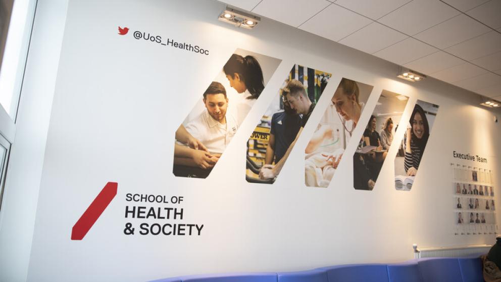 School of Health and Society wall display in Allerton Building featuring images covering different subject areas
