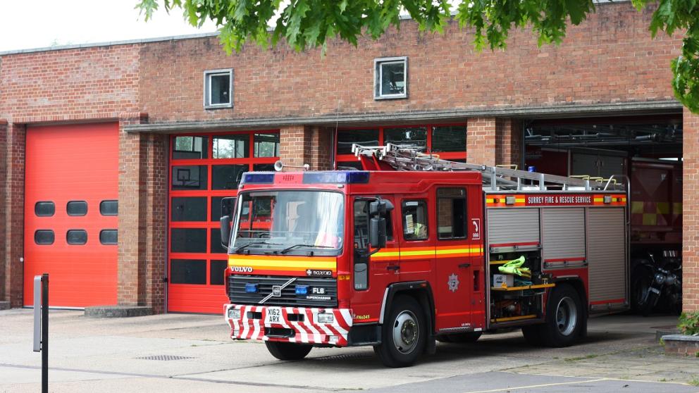 Fire engine parked outside a fire station building