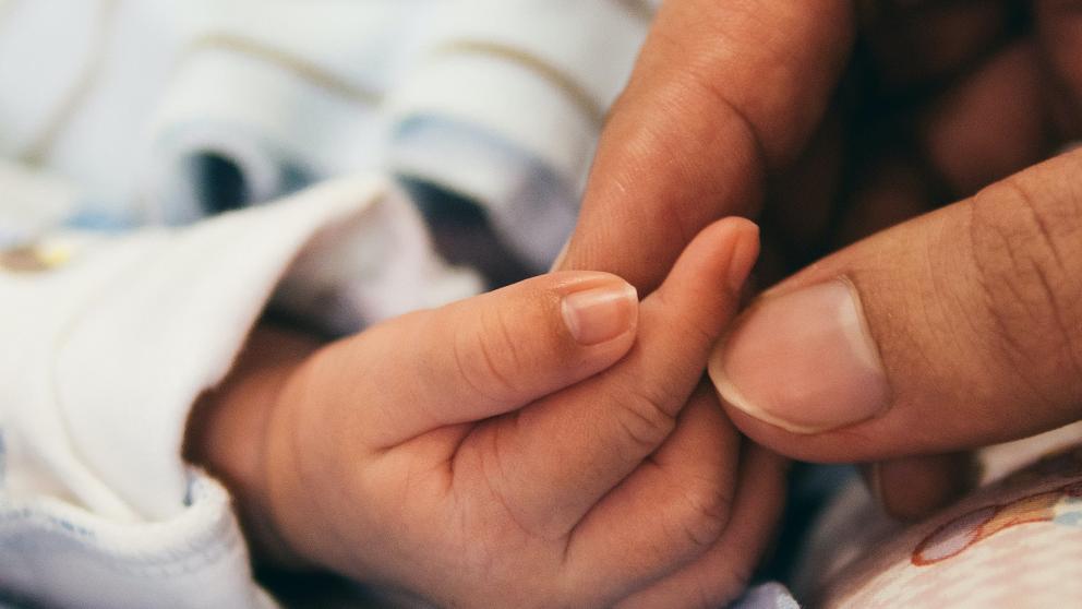 Newborn holding hand
