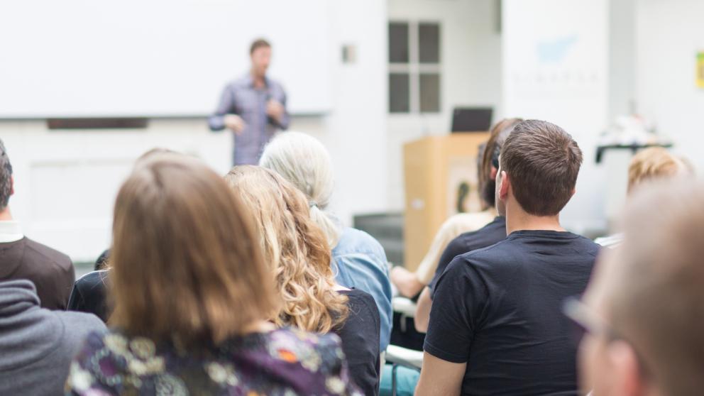 A man teaching in class banner
