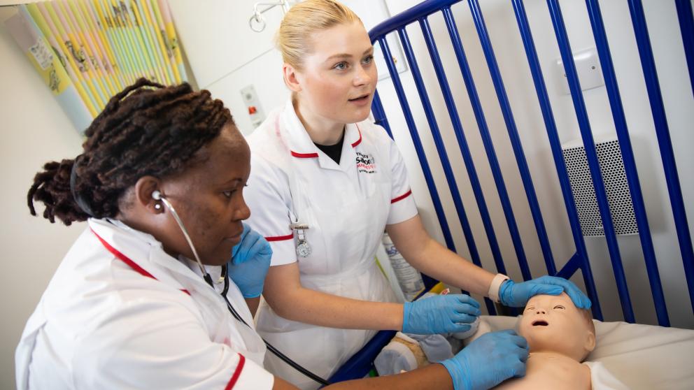 International nursing students practicing on a child mannikin in the simulation suites