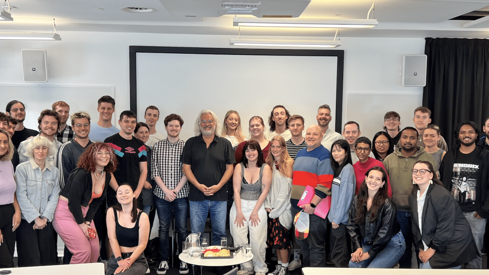 Honorary Professor Paul Greengrass with a group of students