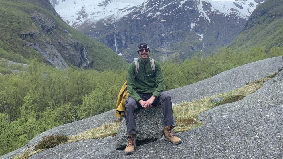 Graduate Kory Le Moore on a mountain side