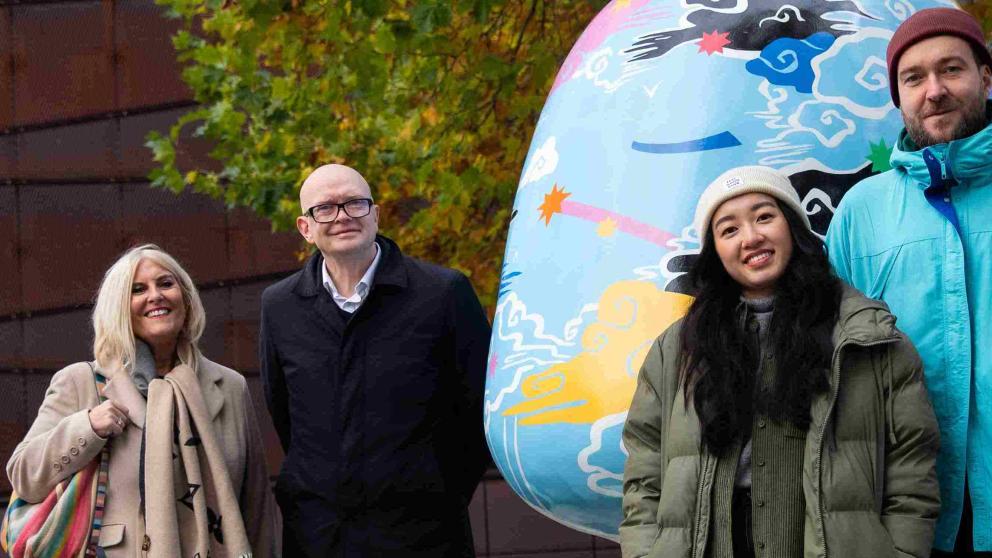 University colleagues and the creators of Embrace in Chapman Square