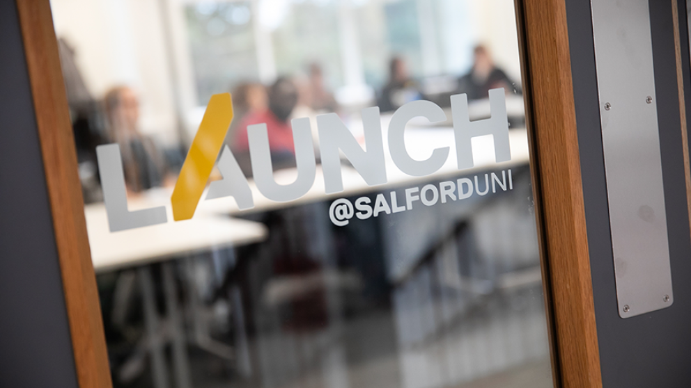 Launch incubator sticker on the window of a door.