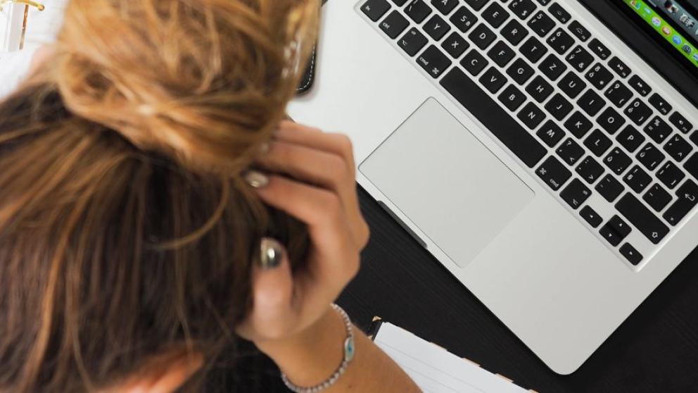 Woman working with head in hands