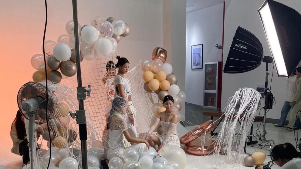 Models pose on a fashion photography set 