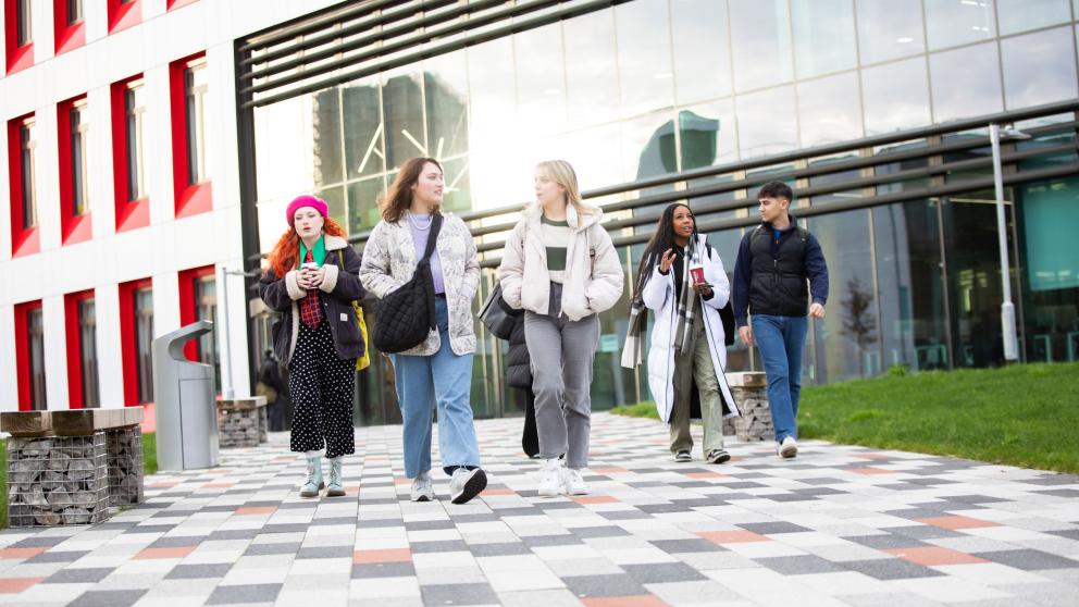 A group of students outside the Science, Engineering & Environment (SEE) Building, University of Salford