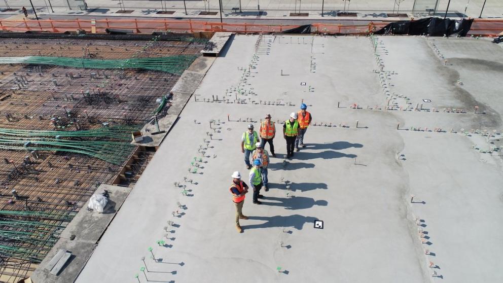 Seven people standing on a construction site
