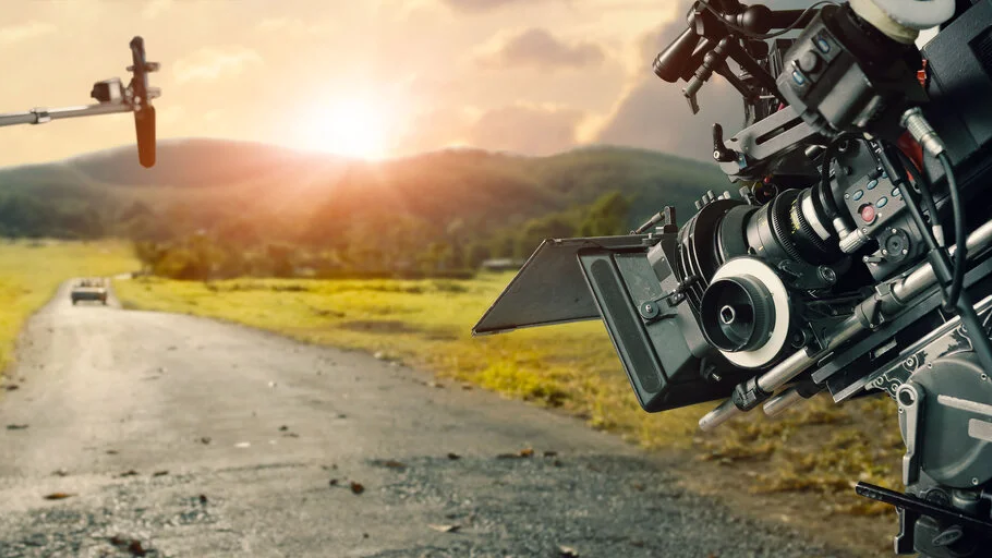 Image shows a camera and a boom mic on an open track