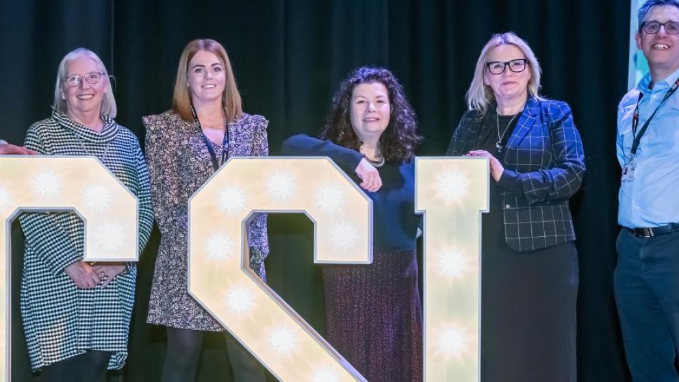 CSI team with lit up lettering