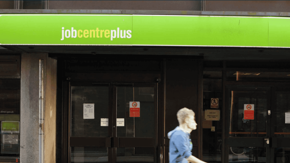 man walking past job centre