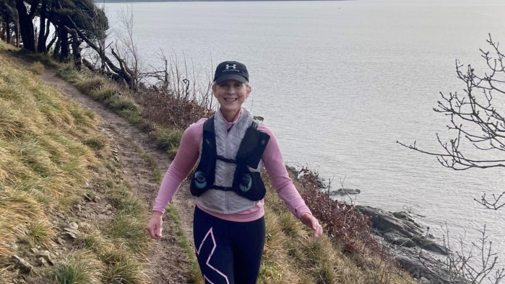 Natalie Yates-Bolton walking alongside coast