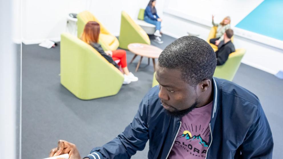 Students taking notes on a big whiteboard