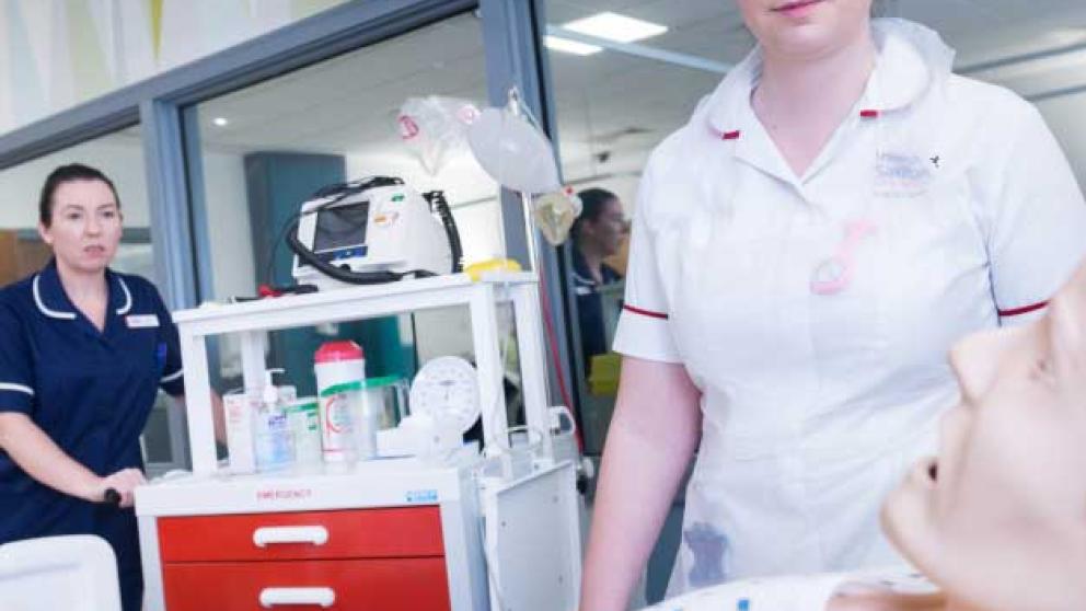 Student nurse using simulation suites that replicate a real hospital ward environment 