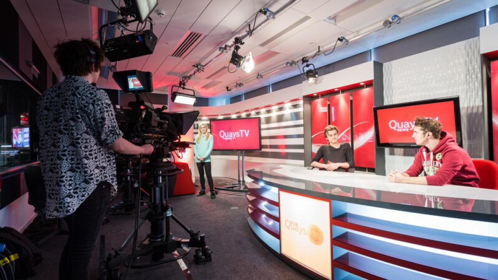Students filming in a broadcast studio