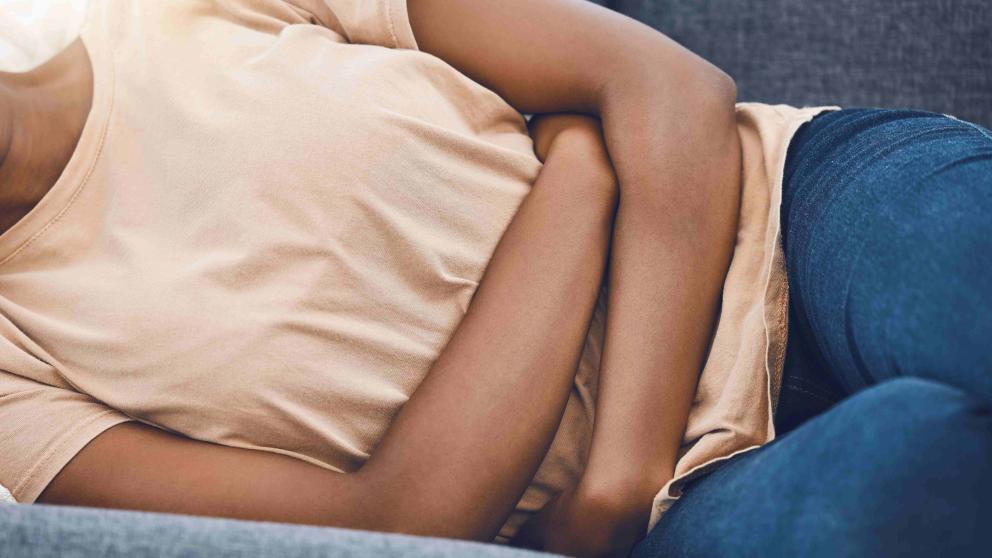 Woman with folded arms on a settee