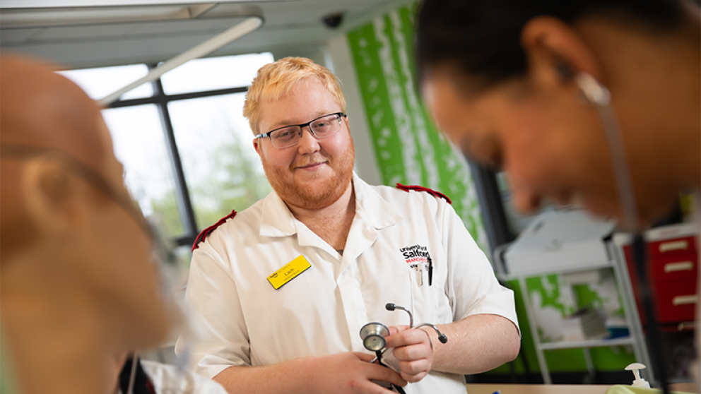 Nursing student conducting physiological observations with a stethoscope in hand
