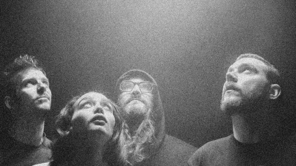 A group of people stare up at a light in a pixelated image