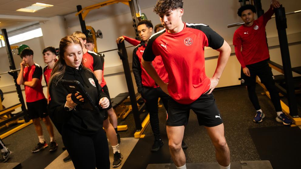 Female student conducting performance assessment with a player from Fleetwood Town FC