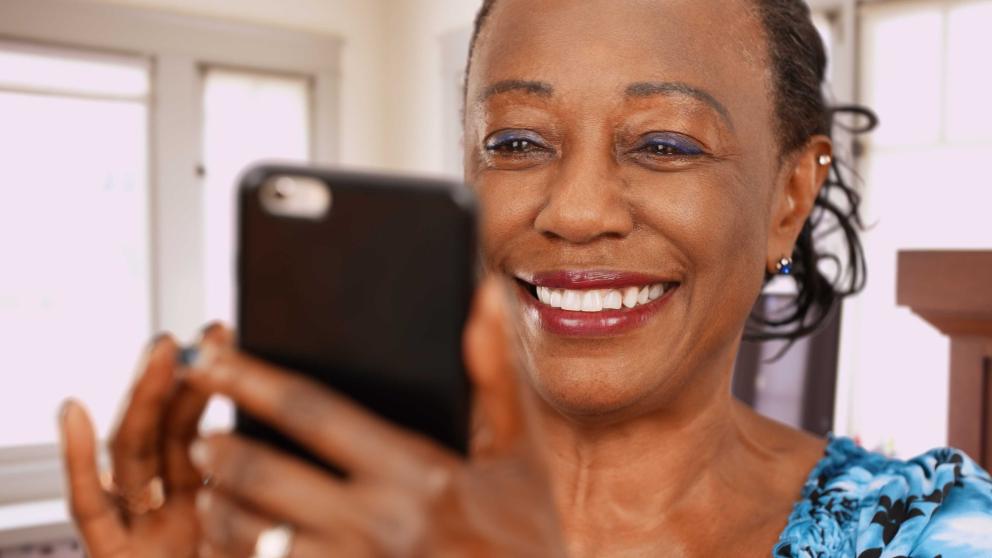 Lady looking at Bumble app on phone 