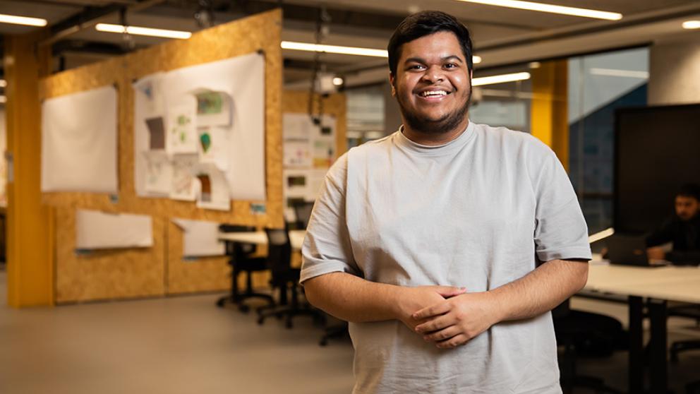 Student smiling inside the University of Salford's Architecture studios