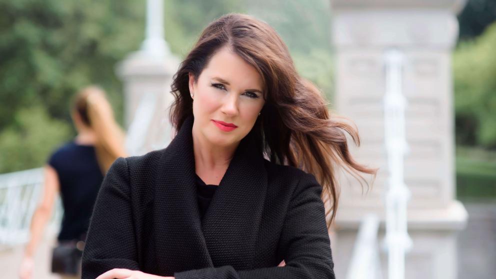 Caroline Redman Lusher in a windswept shot in a park 